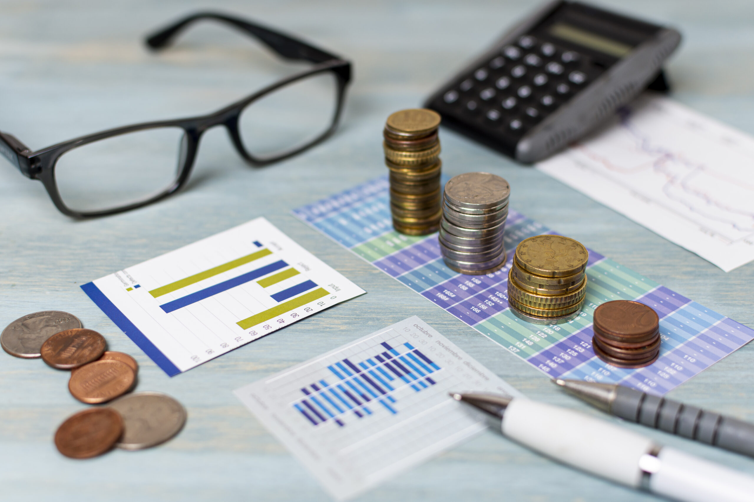 reading glasses piles coins high view scaled