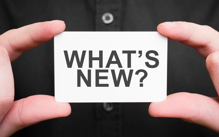 businessman holding card with text whats new business concept 301012 7442